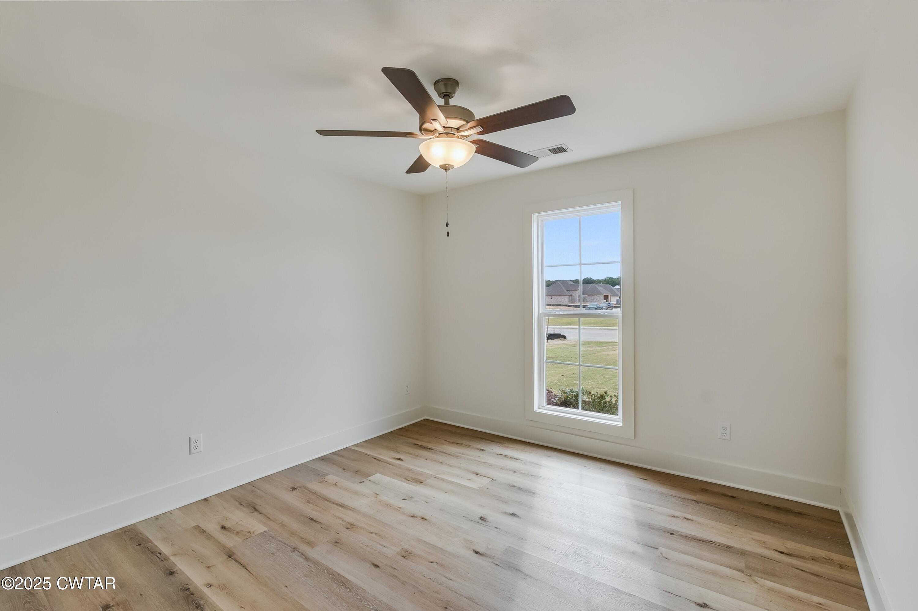 110 Daybreak Loop Medina, TN 38355 - Photo 15 of 21 a view of an empty room with window and wooden floor