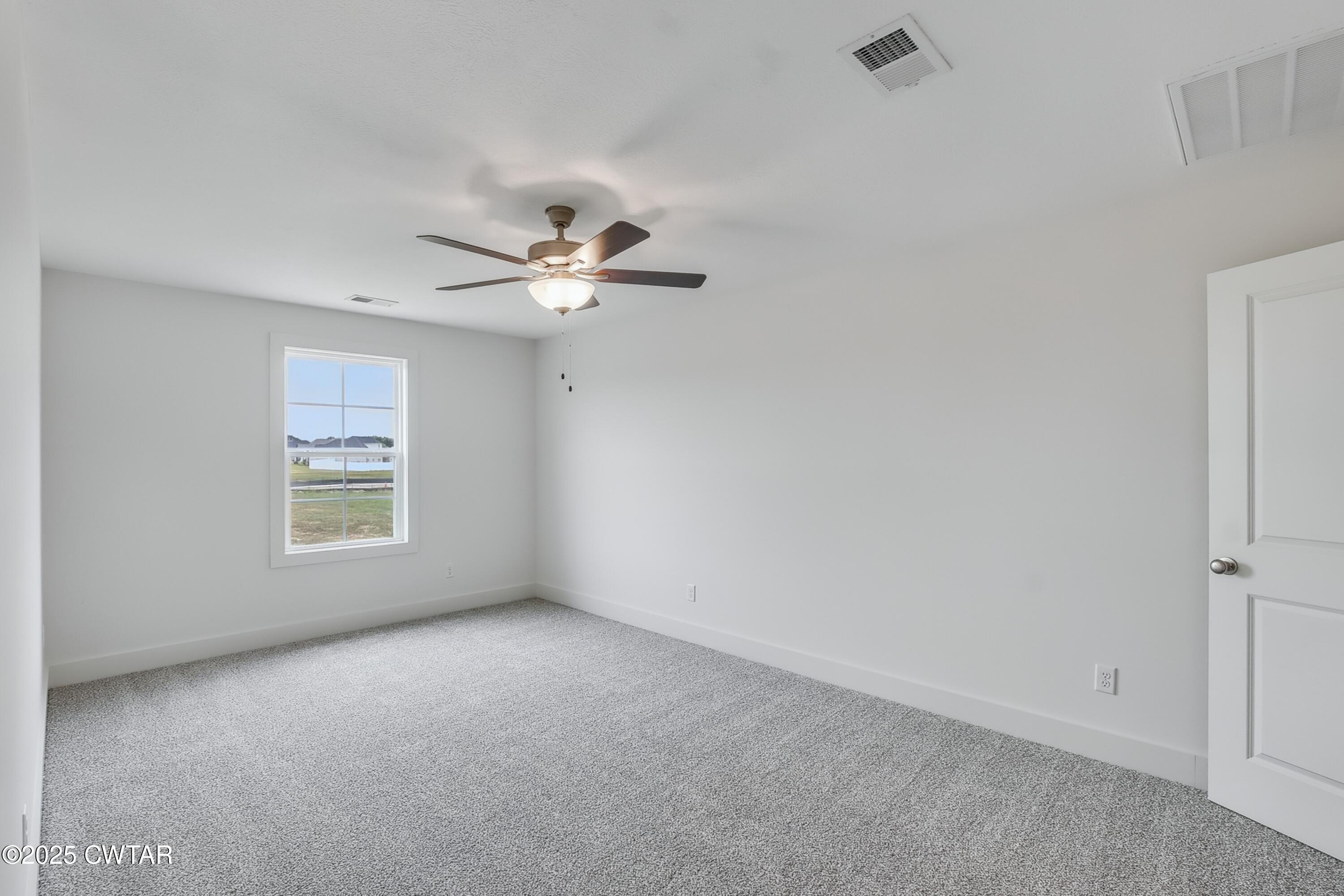 110 Daybreak Loop Medina, TN 38355 - Photo 18 of 21 a view of an empty room with a chandelier fan