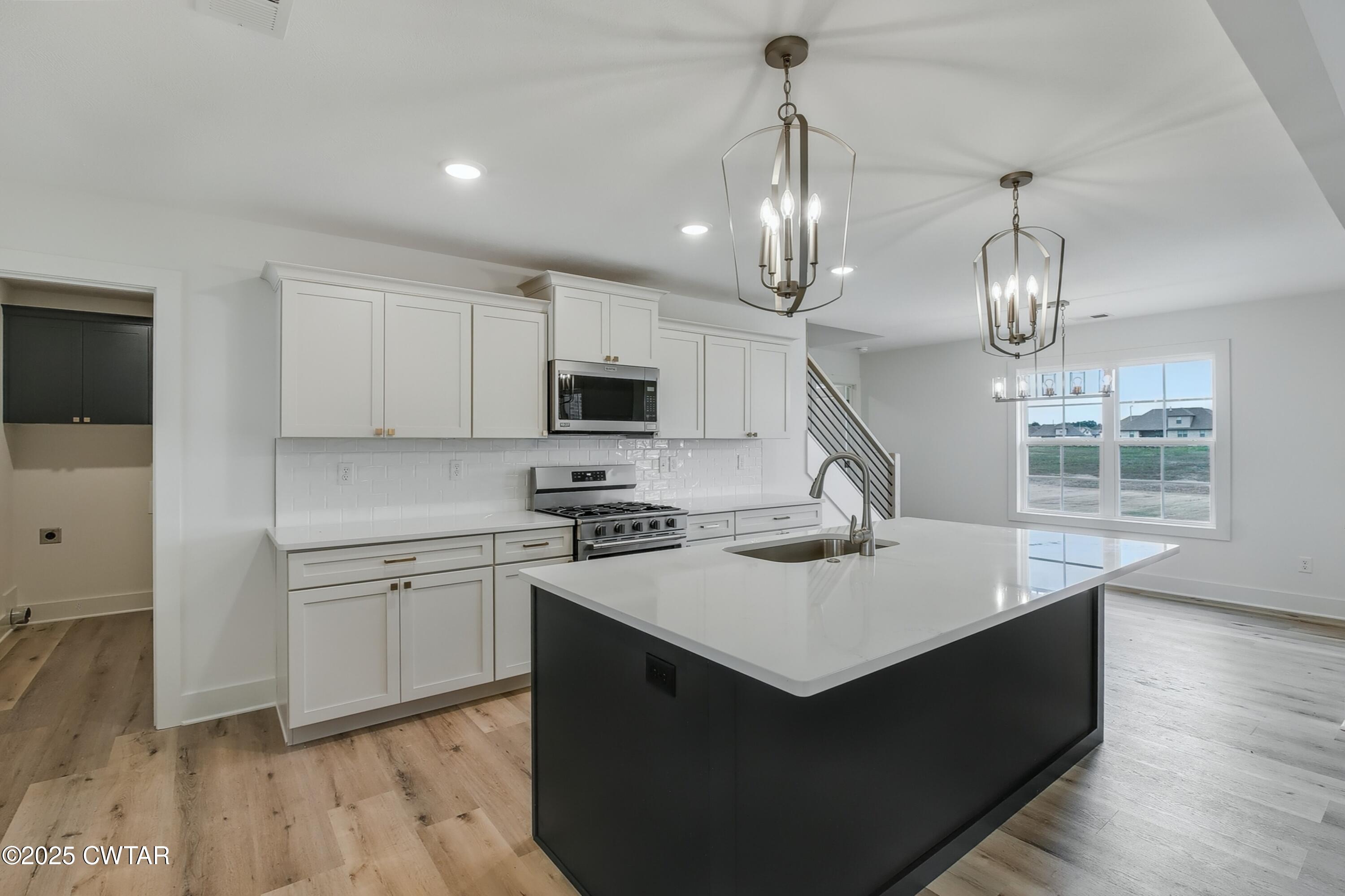110 Daybreak Loop Medina, TN 38355 - Photo 4 of 21 a kitchen with sink cabinets and wooden floor