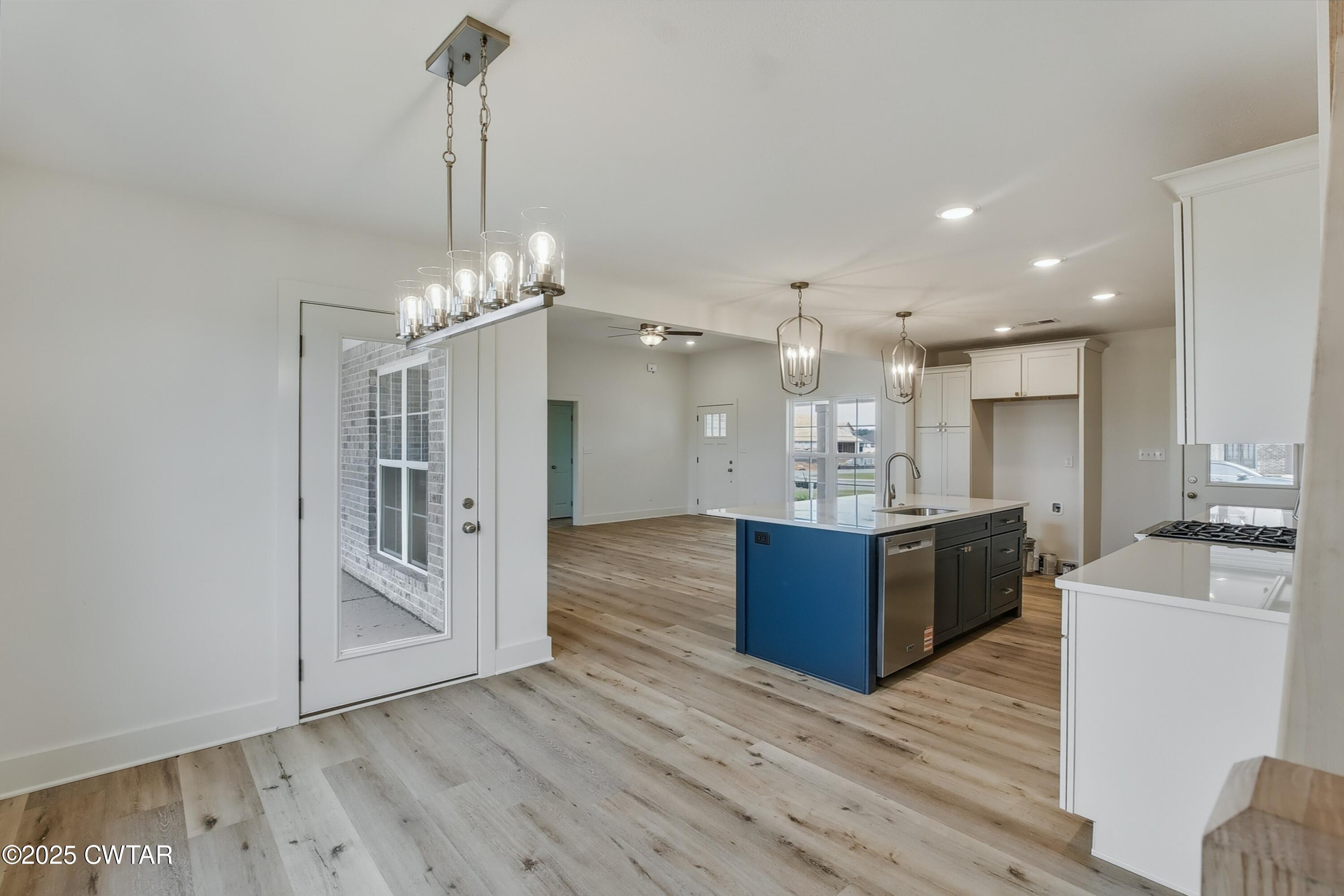 110 Daybreak Loop Medina, TN 38355 - Photo 7 of 21 a large kitchen with kitchen island a sink stainless steel appliances and a chandelier
