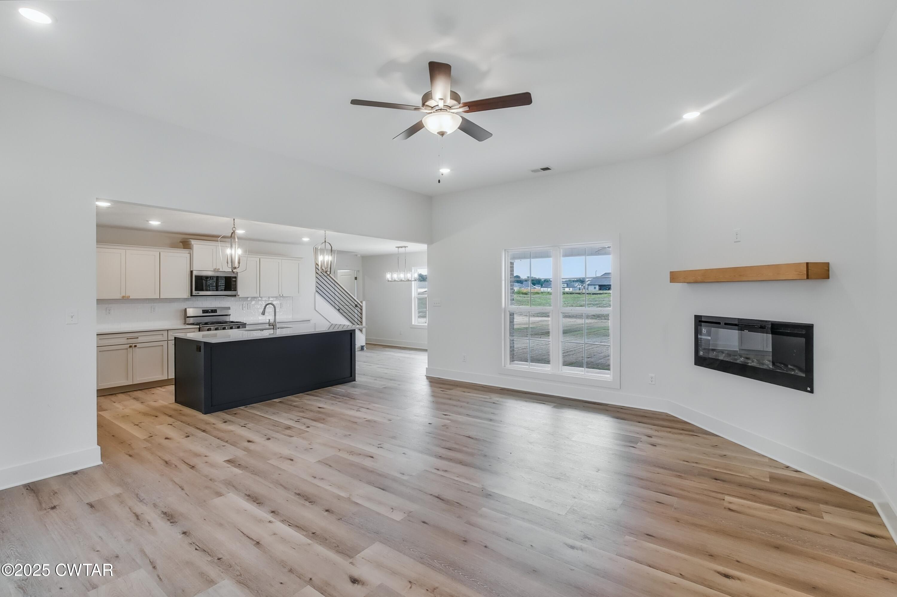 110 Daybreak Loop Medina, TN 38355 - Photo 8 of 21 a large white kitchen with a large window a sink and stainless steel appliances