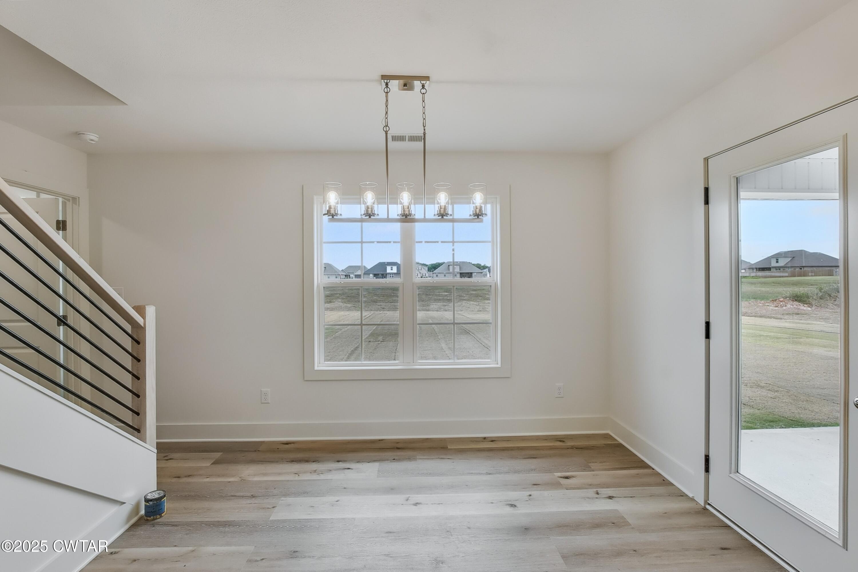 110 Daybreak Loop Medina, TN 38355 - Photo 10 of 21 a view of a room with window wooden floor and chandelier