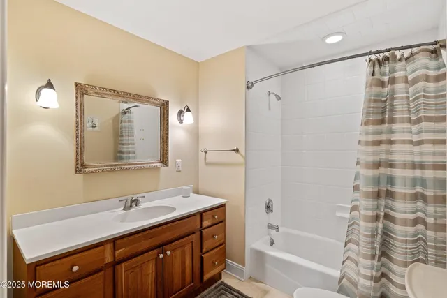 a bathroom with a tub sink and mirror
