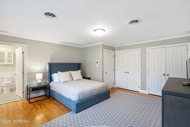 a bedroom with a large bed and a night stand