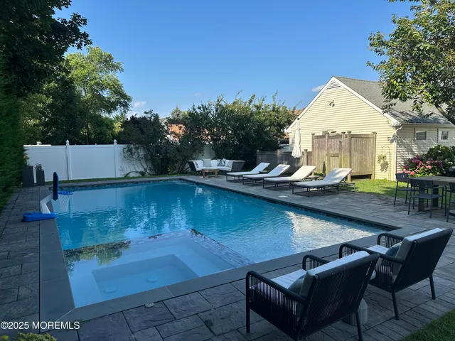 a view of a backyard with sitting area
