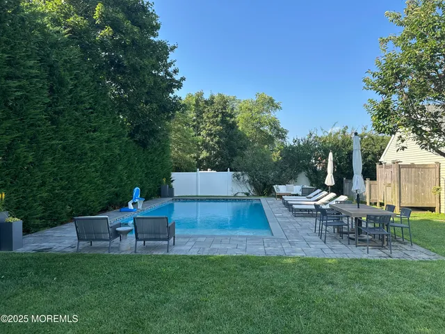 a backyard of a house with table and chairs
