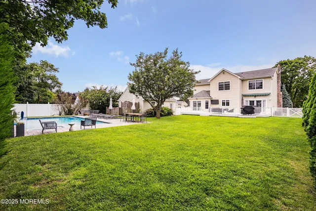 a house view with swimming pool in front of it