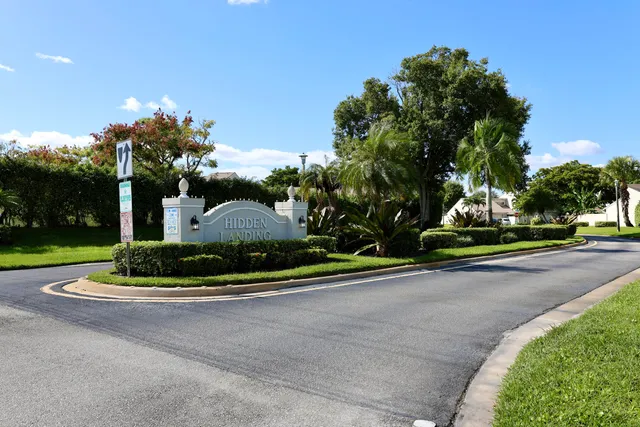 a white house with a yard and plants