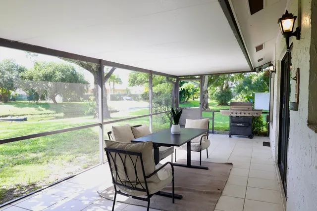 a view of a porch with chairs and backyard