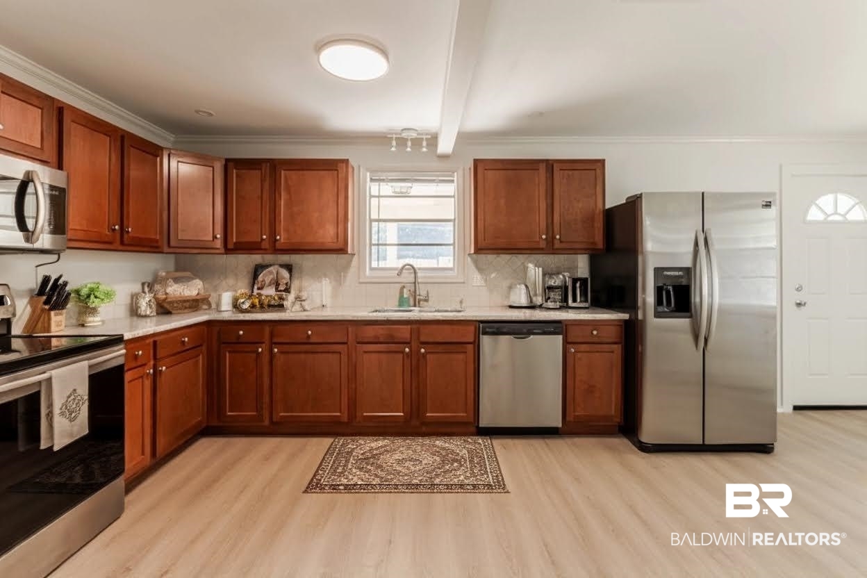 3970 Oak Ridge Avenue Mobile, AL 36619 - Photo 6 of 28 Kitchen featuring beamed ceiling, backsplash, sink, appliances with stainless steel finishes, and light hardwood / wood-style floors