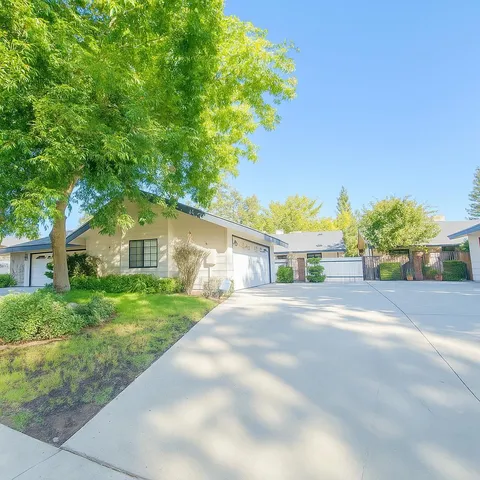 a front view of a house with a yard and a garage