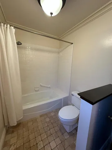 a bathroom with a toilet and a shower