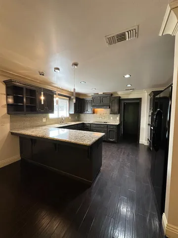 a large kitchen with stainless steel appliances kitchen island granite countertop a large counter top and stove