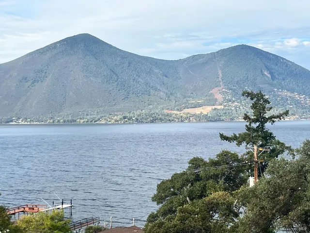 a view of a lake in middle of a field