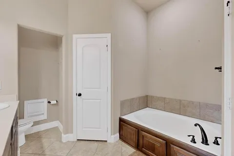 a bathroom with a tub and toilet