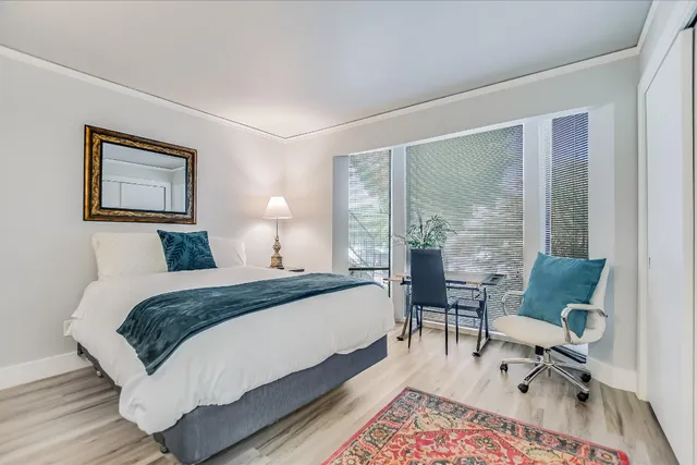 a bed room with a bed and a desk