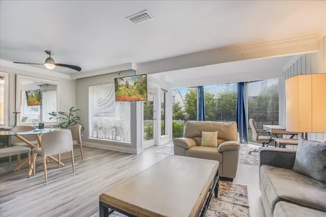 a living room with furniture and wooden floor