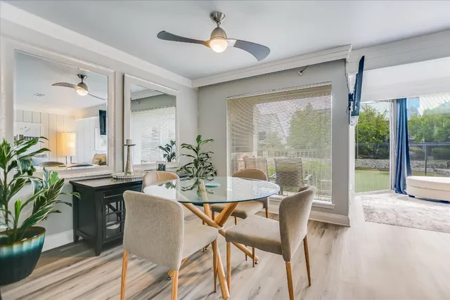 a view of a dining room with furniture window and wooden floor