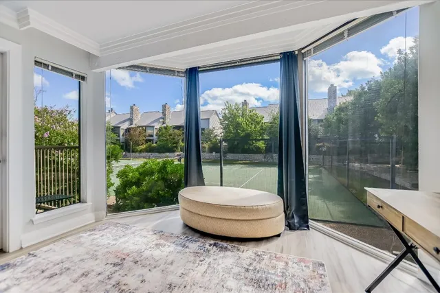 a view of a room with a bed and wooden floor