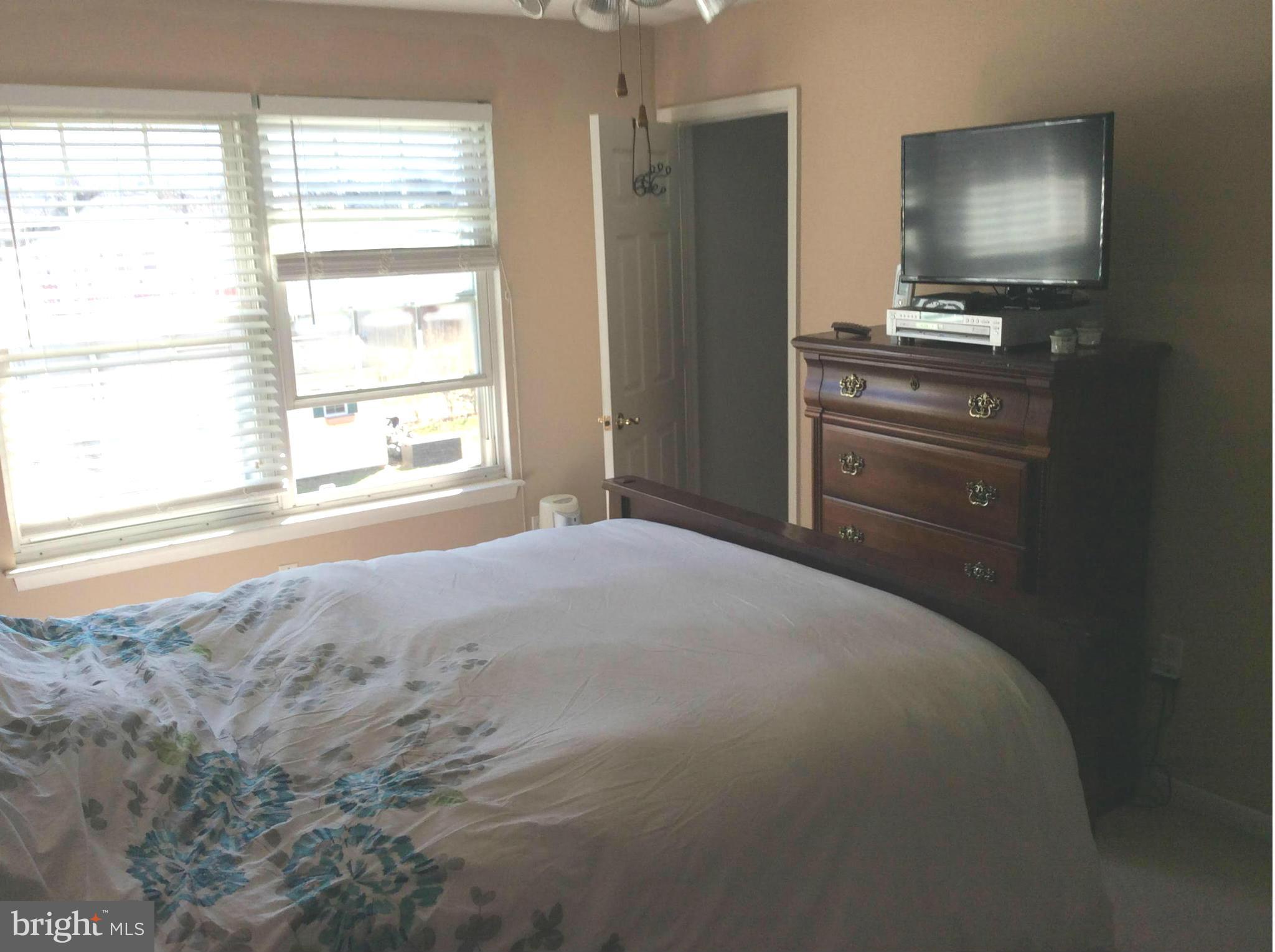 875 Sycamore Hill Road Severn, MD 21144 - Photo 8 of 17 a bedroom with a bed and a flat screen tv