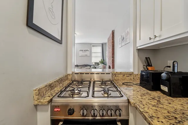 a stove top oven sitting inside of a kitchen