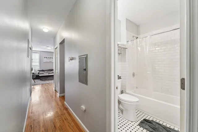 a bathroom with a bathtub toilet and shower