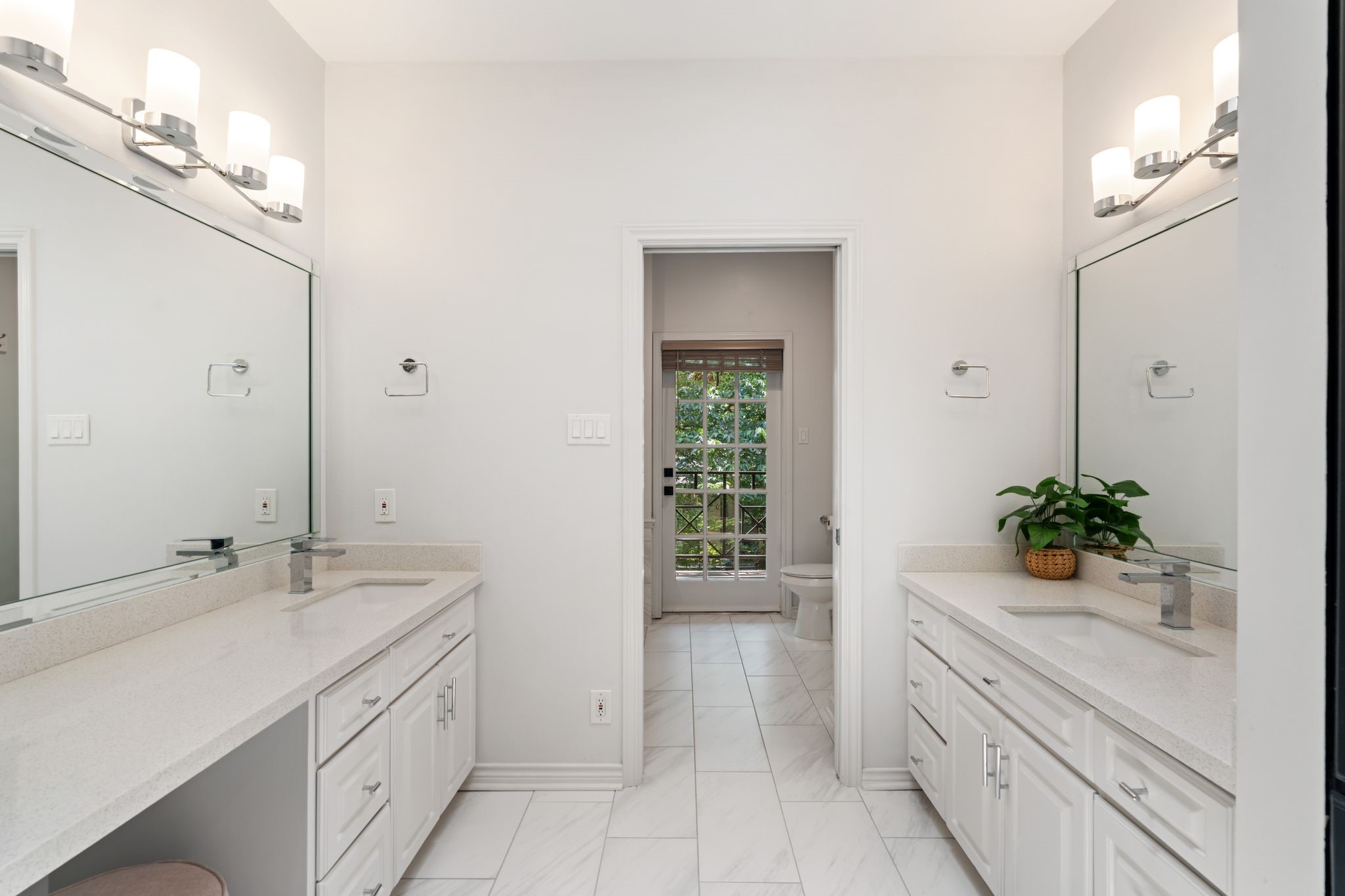 201 Vanderpool Lane, Unit 137 Houston, TX 77024 - Photo 22 of 42 Bright, spacious, and thoughtfully designed with dual vanities, separate sinks, oversized framed mirrors, and classic vanity lighting. Quartz countertops, marble-look tile floors, and abundant cabinetry and drawer storage make the space both beautiful and functional. A built-in makeup/sitting area adds an extra touch of luxury, while the skylight fills the bathroom with gorgeous natural light throughout the day.