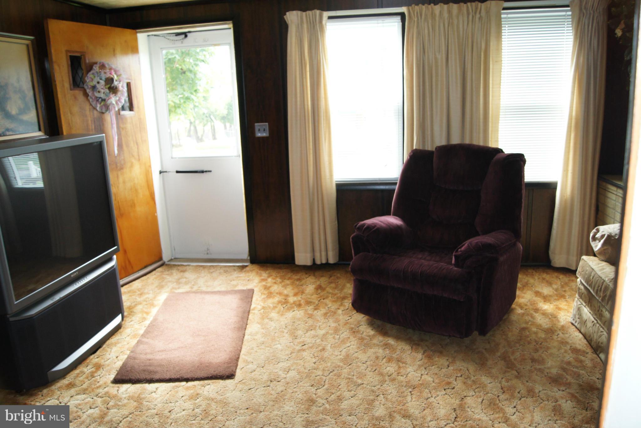1906 Searles Road Baltimore, MD 21222 - Photo 4 of 13 a living room with furniture window and a flat screen tv