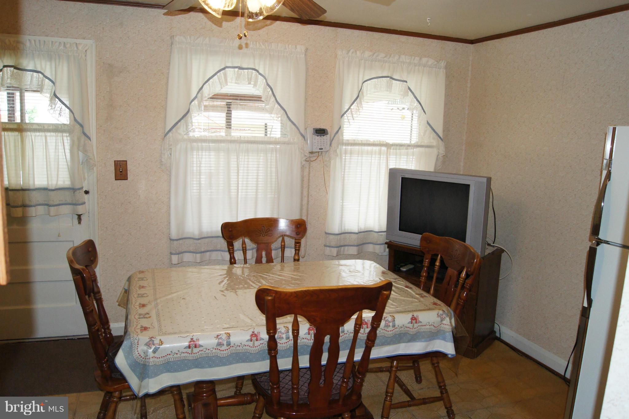 1906 Searles Road Baltimore, MD 21222 - Photo 5 of 13 a view of a dining room with furniture and window