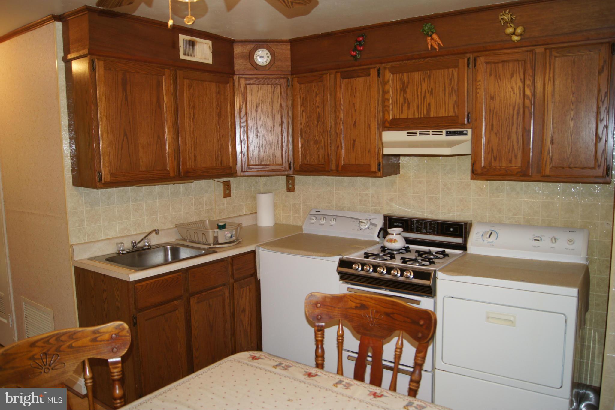 1906 Searles Road Baltimore, MD 21222 - Photo 6 of 13 a kitchen with a sink a stove and cabinets