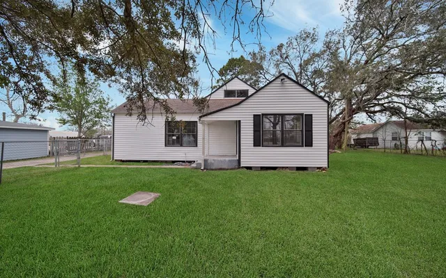 a white house that has a tree in it
