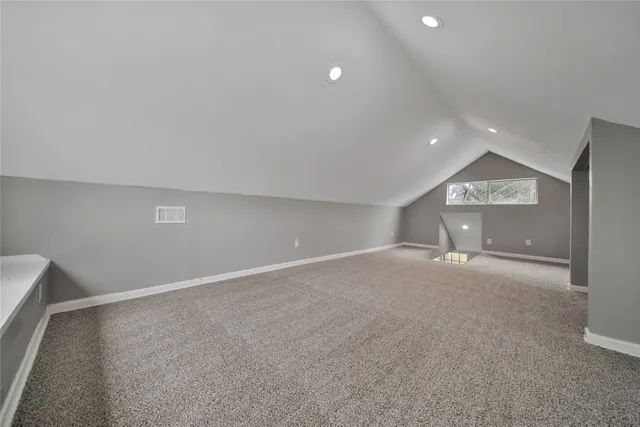 a view of an empty room and a window