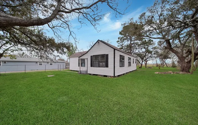 a view of a house with a backyard