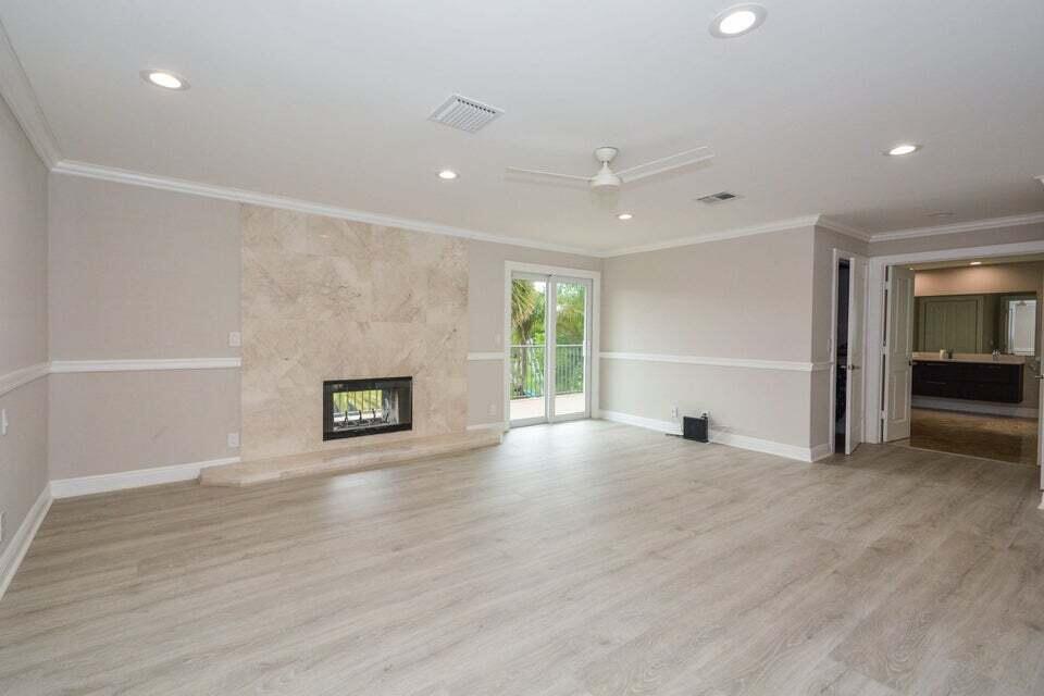 934 Southwest 21st Way Boca Raton, FL 33486 - Photo 14 of 25 an empty room with wooden floor and fireplace