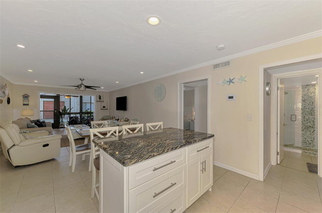 1612 Stickney Point Road, Unit 16121 Sarasota, FL 34231 - Photo 13 of 39 a view of living room with granite countertop furniture and fireplace