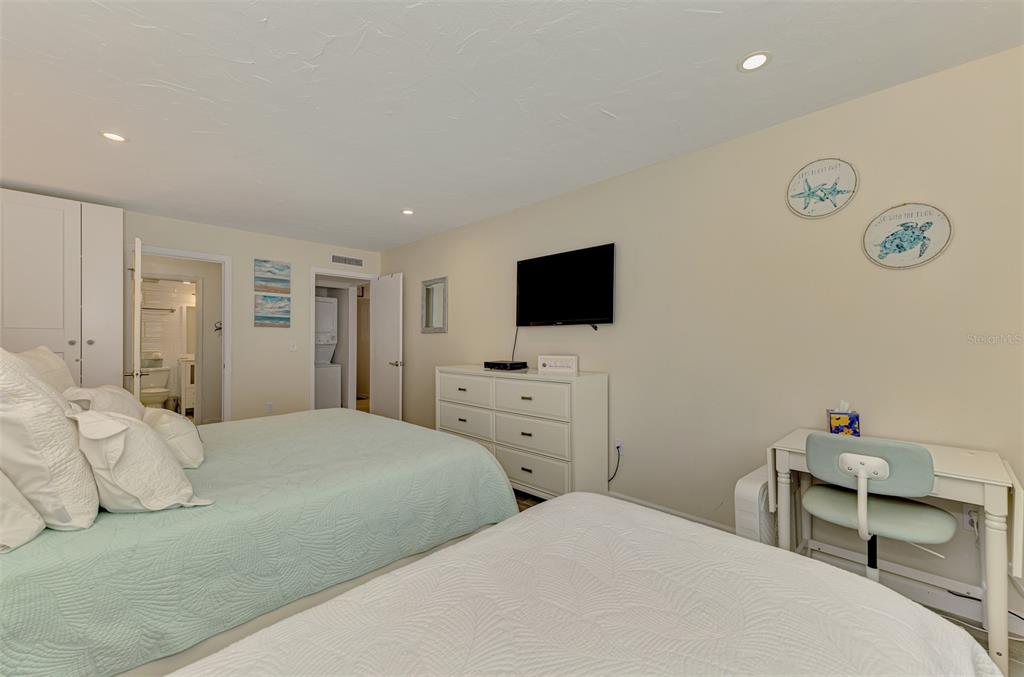 1612 Stickney Point Road, Unit 16121 Sarasota, FL 34231 - Photo 23 of 39 a bedroom with a bed and a flat screen tv