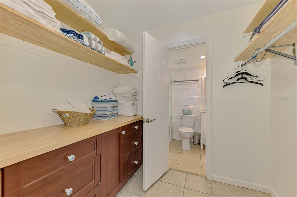 1612 Stickney Point Road, Unit 16121 Sarasota, FL 34231 - Photo 24 of 39 a bathroom with a granite countertop sink a toilet and a shower