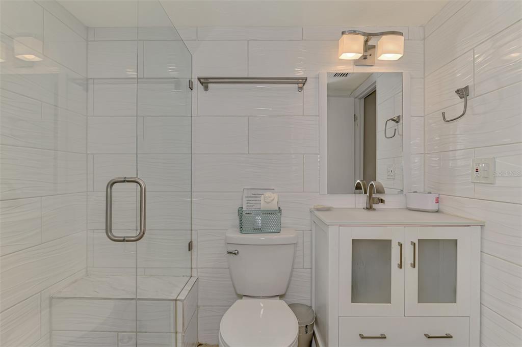 1612 Stickney Point Road, Unit 16121 Sarasota, FL 34231 - Photo 25 of 39 a bathroom with a toilet sink and shower