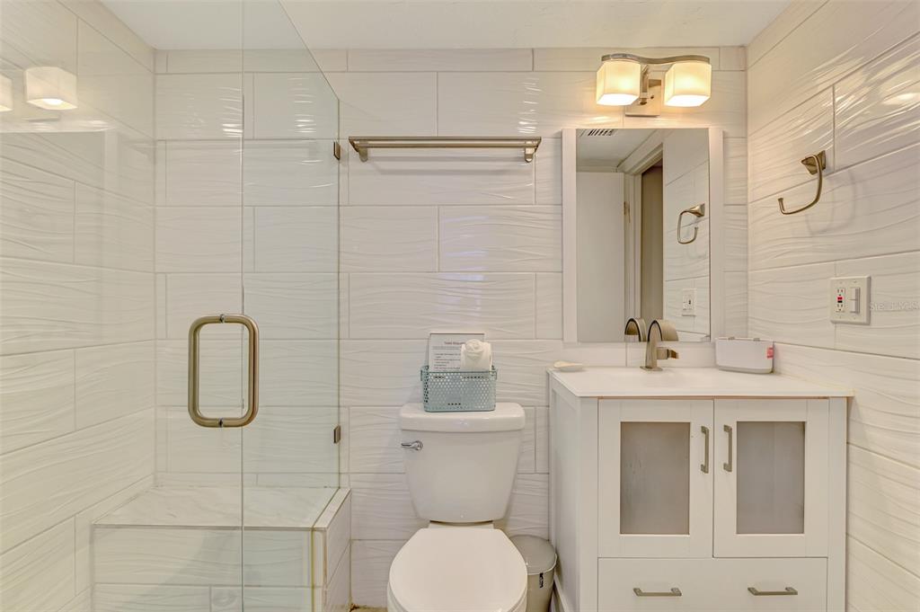 1612 Stickney Point Road, Unit 16121 Sarasota, FL 34231 - Photo 26 of 39 a bathroom with a toilet sink and shower