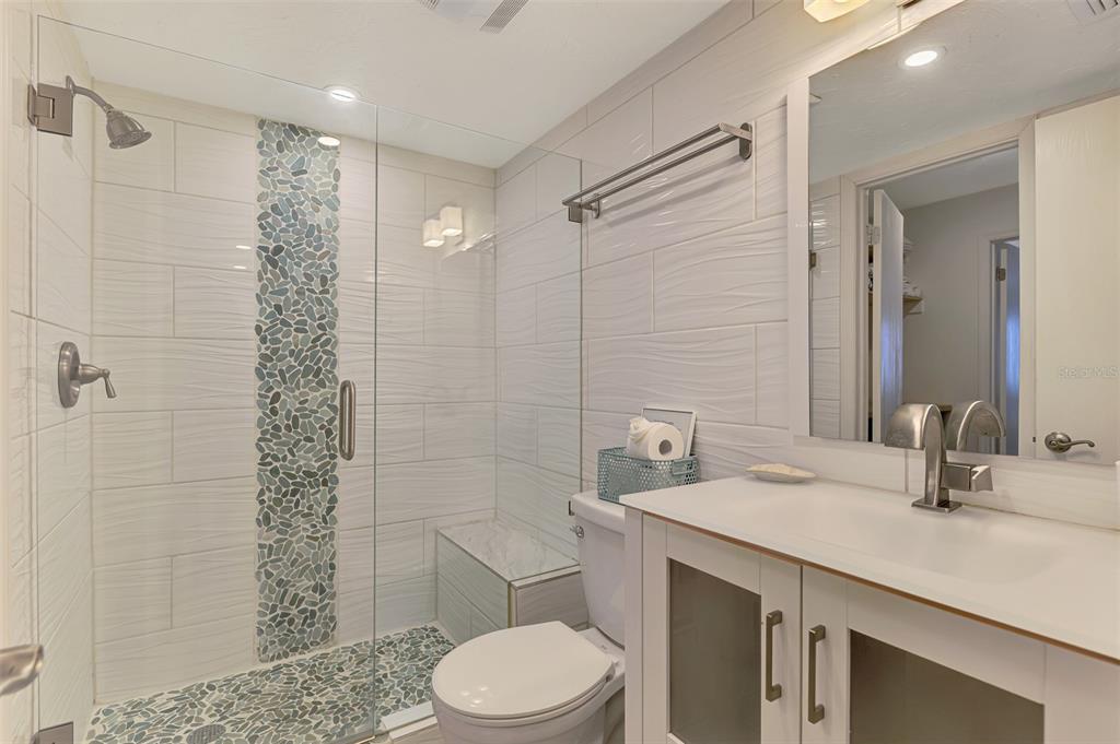 1612 Stickney Point Road, Unit 16121 Sarasota, FL 34231 - Photo 27 of 39 a bathroom with a sink a toilet and shower