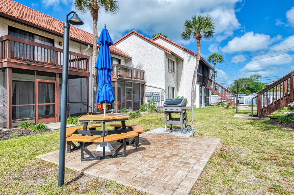 1612 Stickney Point Road, Unit 16121 Sarasota, FL 34231 - Photo 31 of 39 a view of a house with backyard porch and sitting area