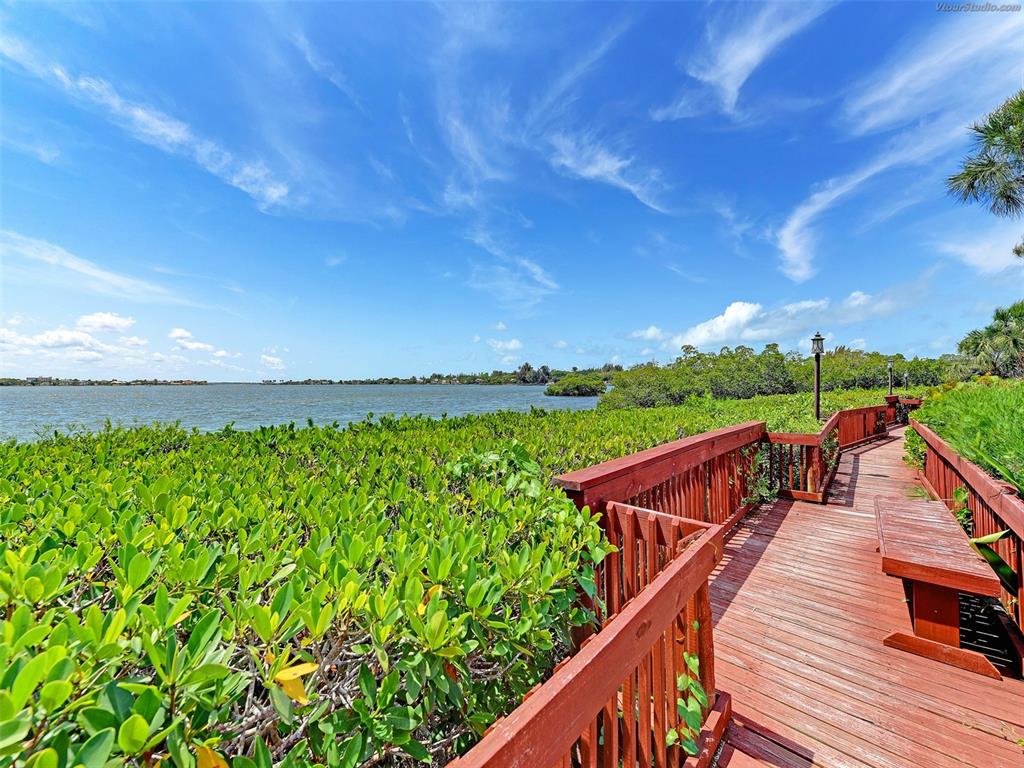 1612 Stickney Point Road, Unit 16121 Sarasota, FL 34231 - Photo 39 of 39 a view of a wooden deck with a yard