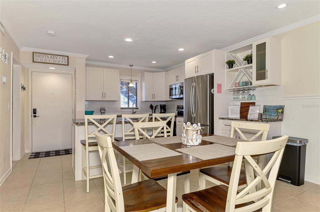 1612 Stickney Point Road, Unit 16121 Sarasota, FL 34231 - Photo 6 of 39 a view of a dining room with furniture