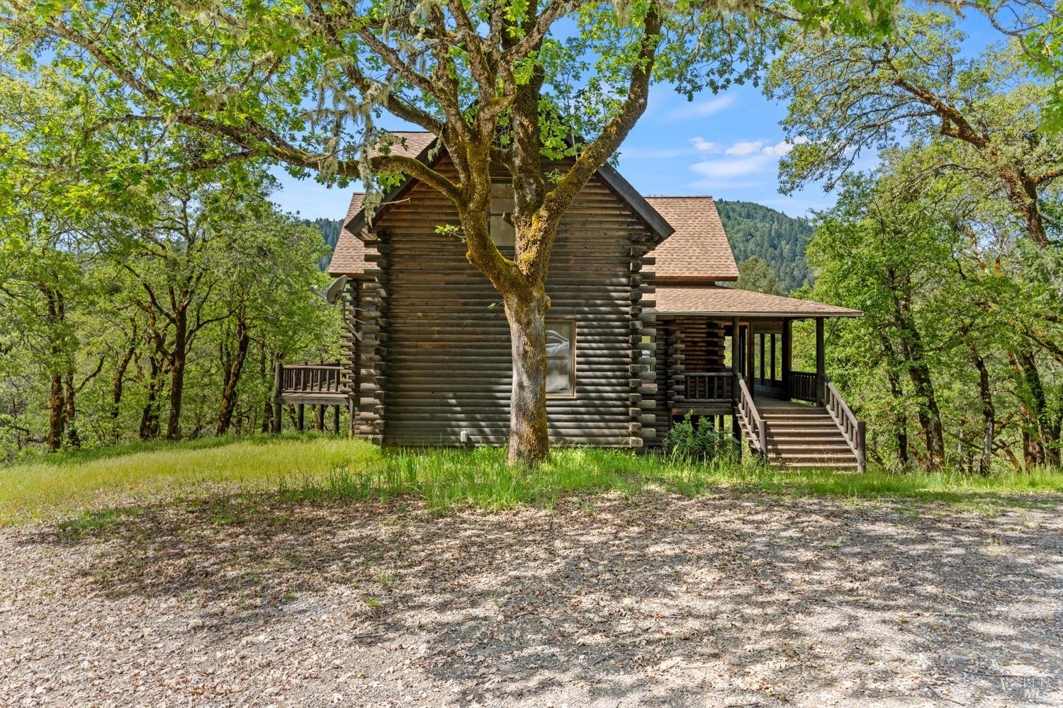 31100 Shimmins Ridge Road Willits, CA 95490 - Photo 1 of 1 a front view of a house with garden