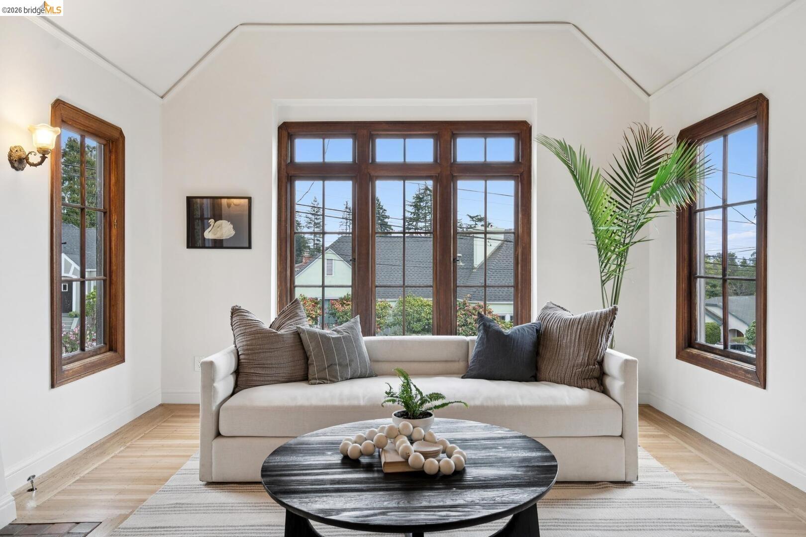 4107 Lyman Road Oakland, CA 94602 - Photo 11 of 57 Living room featuring vaulted ceiling, light wood finished floors, and arched walkways