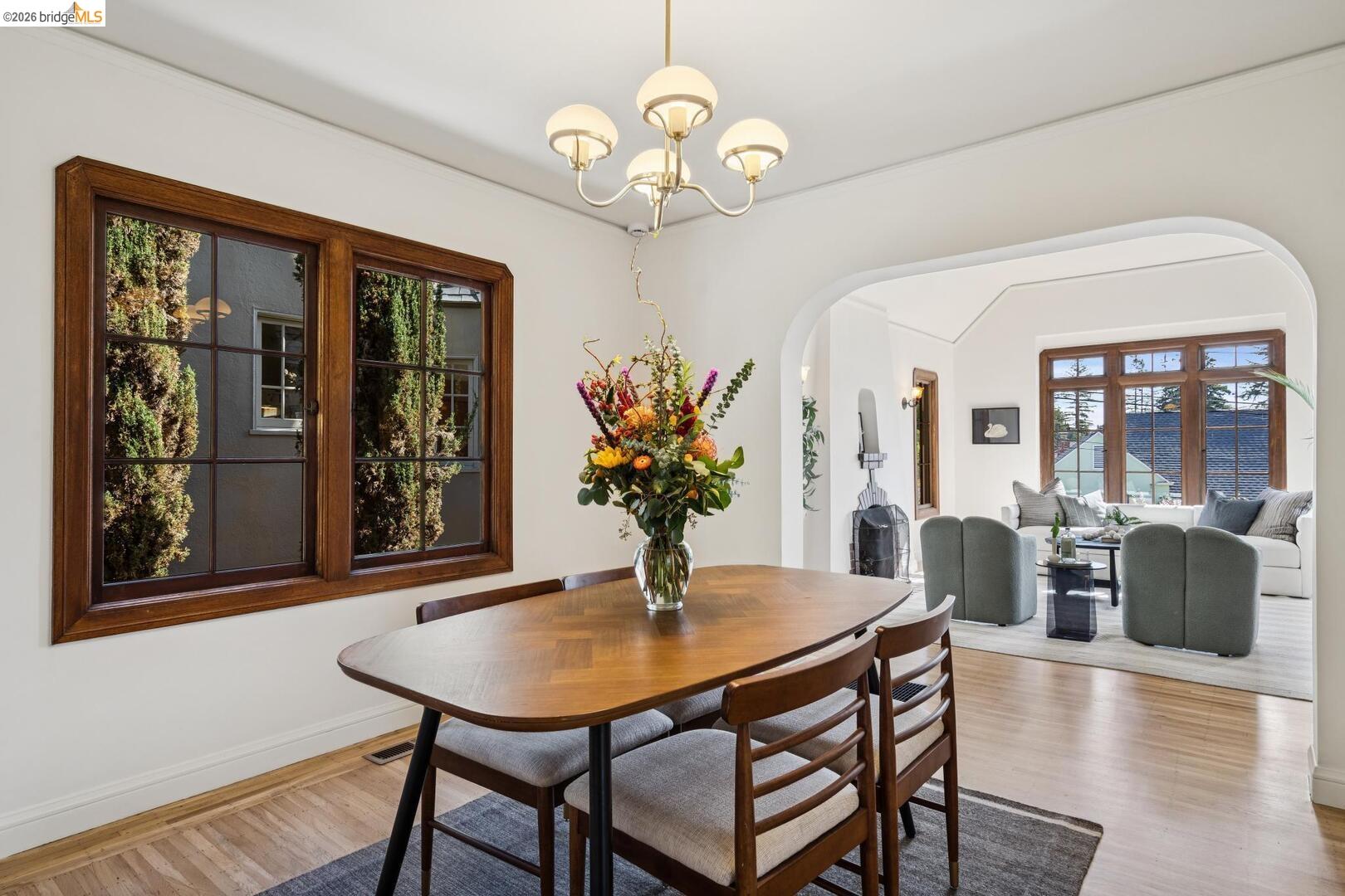 4107 Lyman Road Oakland, CA 94602 - Photo 15 of 57 Kitchen with stainless steel appliances, pendant lighting, white cabinets, light wood-style flooring, and light stone counters