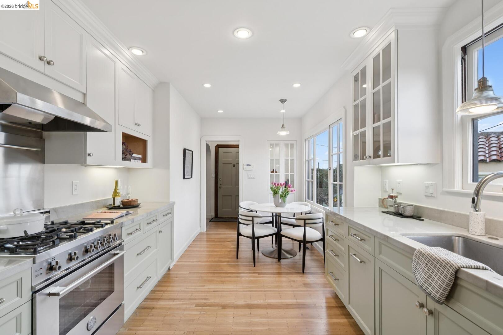 4107 Lyman Road Oakland, CA 94602 - Photo 20 of 57 Kitchen featuring glass fronted cabinets, white cabinetry, and stainless steel dishwasher