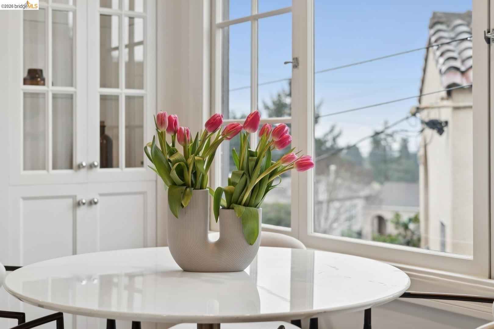 4107 Lyman Road Oakland, CA 94602 - Photo 25 of 57 Dining room featuring light wood-style flooring, arched walkways, and ornamental molding