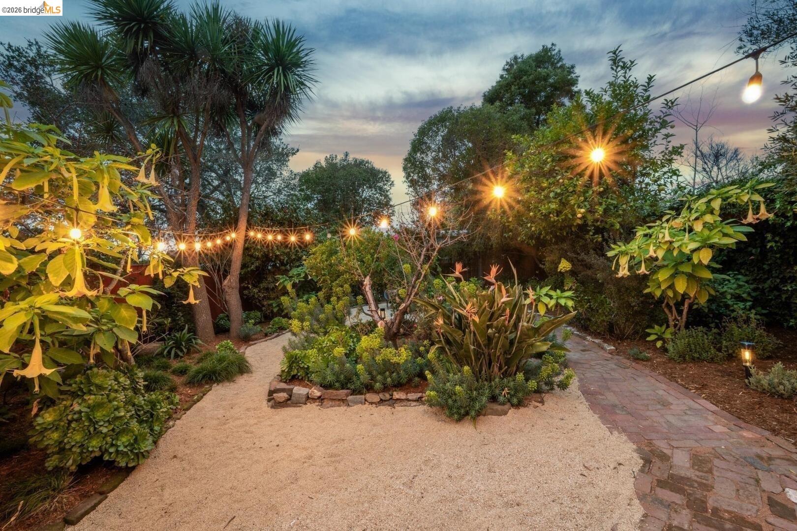 4107 Lyman Road Oakland, CA 94602 - Photo 49 of 57 Living area featuring a fireplace, healthy amount of natural light, wood finished floors, arched walkways, and lofted ceiling