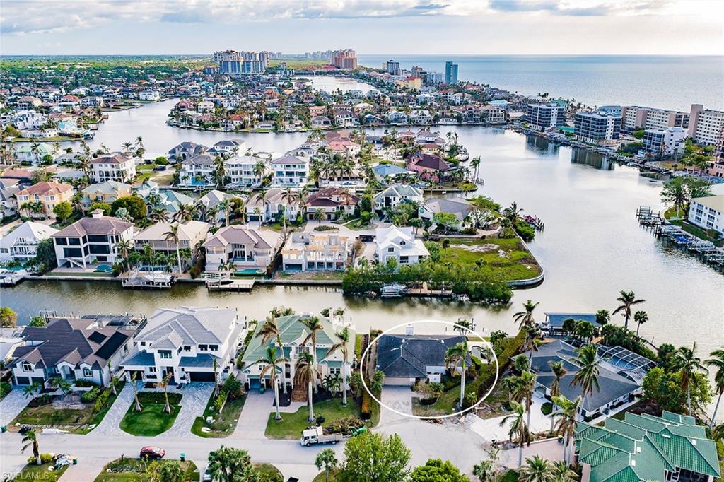 128 Heron Avenue Naples, FL 34108 - Photo 3 of 12 an aerial view of a house with a lake view